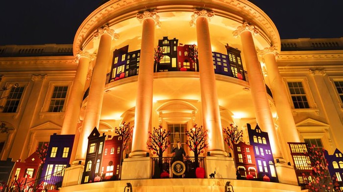 President Joe Biden and first lady Jill Biden wave after giving treats to trick-or-treaters on the South Lawn of the White House, on Halloween, Monday, Oct. 31, 2022, in Washington. (AP Photo/Alex Brandon)