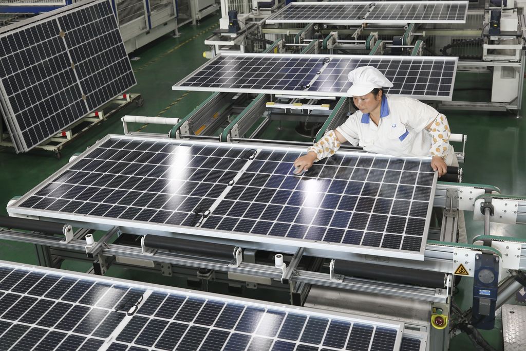 LIANYUNGANG, CHINA - NOVEMBER 2, 2022 - A worker at a photovoltaic company rushes to make solar photovoltaic panels for export in Lianyungang, Jiangsu Province, China, Nov 2, 2022. Since this year, influenced by the acceleration of the global energy transition to low carbon, the export of photovoltaic products in Lianyungang City has shown explosive growth. Some enterprises' orders have been arranged into the first quarter of next year. Local enterprises have stepped up order production to ensure the supply of domestic and foreign markets. (Photo credit should read CFOTO/Future Publishing via Getty Images)