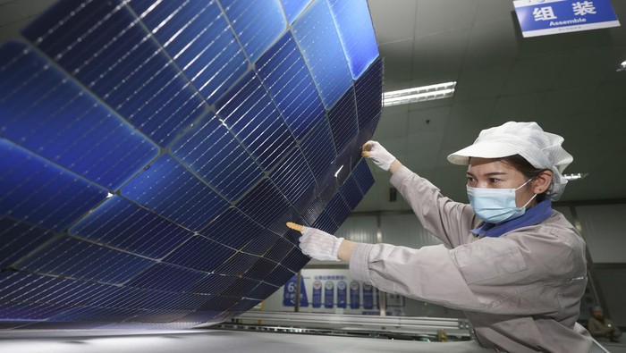 LIANYUNGANG, CHINA - NOVEMBER 2, 2022 - A worker at a photovoltaic company rushes to make solar photovoltaic panels for export in Lianyungang, Jiangsu Province, China, Nov 2, 2022. Since this year, influenced by the acceleration of the global energy transition to low carbon, the export of photovoltaic products in Lianyungang City has shown explosive growth. Some enterprises' orders have been arranged into the first quarter of next year. Local enterprises have stepped up order production to ensure the supply of domestic and foreign markets. (Photo credit should read CFOTO/Future Publishing via Getty Images)