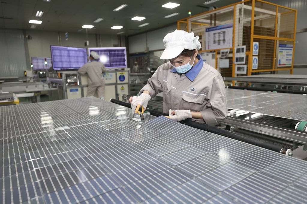 LIANYUNGANG, CHINA - NOVEMBER 2, 2022 - A worker at a photovoltaic company rushes to make solar photovoltaic panels for export in Lianyungang, Jiangsu Province, China, Nov 2, 2022. Since this year, influenced by the acceleration of the global energy transition to low carbon, the export of photovoltaic products in Lianyungang City has shown explosive growth. Some enterprises' orders have been arranged into the first quarter of next year. Local enterprises have stepped up order production to ensure the supply of domestic and foreign markets. (Photo credit should read CFOTO/Future Publishing via Getty Images)