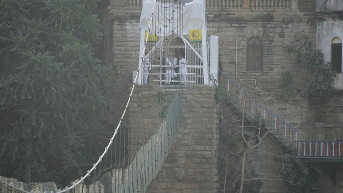 Indian Prime Minister Narendra Modi, above looks at a cable pedestrian bridge that collapsed Sunday in Morbi town of western state Gujarat, India, Tuesday, Nov. 1, 2022. The newly repaired 143-year-old suspension bridge collapsed into a river, sending hundreds plunging into the water and killing at least 135 in one of the country’s worst accidents in years. (AP Photo/Ajit Solanki)