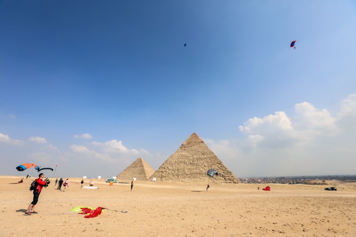 GIZA, EGYPT - NOVEMBER 02: Skydivers fly over the pyramids of Giza during the skydiving festival with the participation of more than a thousand skydivers from 20 states on November 02, 2022, in Giza, Egypt. (Photo by Mohamed Abdel Hamid/Anadolu Agency via Getty Images)