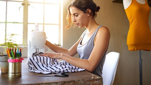 A young designer making a garment in her workplace