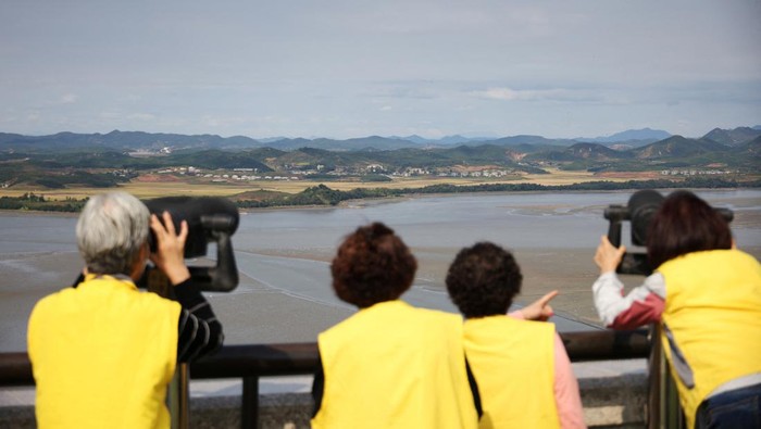 People look at North Korea's propaganda village Kaepoong at the Unification Observation Platform, near the demilitarized zone which separates the two Koreas in Paju, South Korea, October 6, 2022.   REUTERS/Kim Hong-Ji