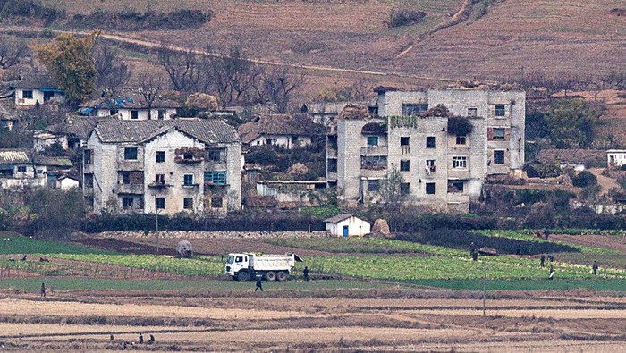 Melihat Kehidupan Warga Desa Kaepoong Korea Utara People look at North Korea's propaganda village Kaepoong at the Unification Observation Platform, near the demilitarized zone which separates the two Koreas in Paju, South Korea, October 6, 2022. REUTERS/Kim Hong-Ji