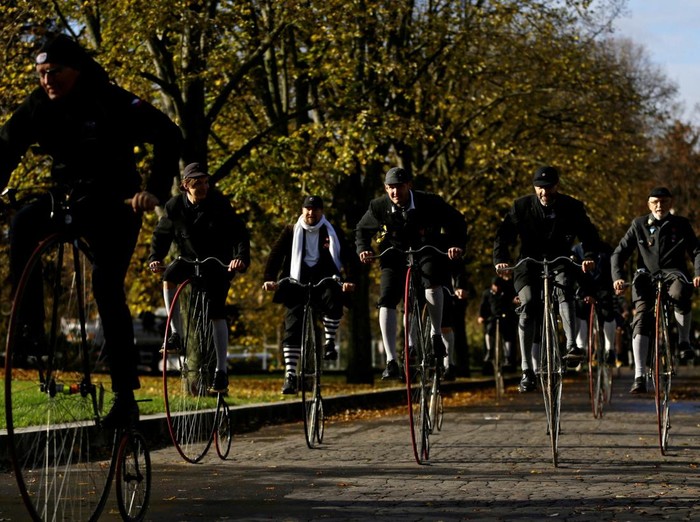 Participants wearing historical costumes ride their high-wheel bicycles during the annual penny farthing race in Prague, Czech Republic, November 5, 2022. REUTERS/David W Cerny