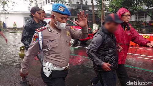 Pria berompi hitam yang diamankan petugas saat kebakaran melanda Balai Kota Bandung