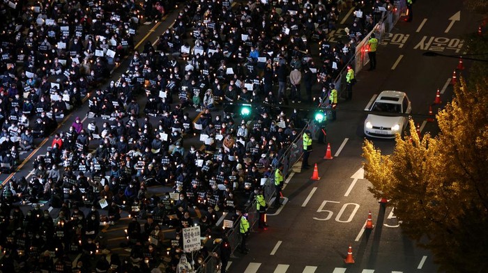 People attend a candlelight vigil to commemorate the victims of the crowd crush that happened during Halloween festivities, at Seoul City Hall Plaza, in Seoul, South Korea, November 5, 2022. REUTERS/Kim Hong-Ji