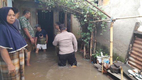 Petugas kepolisian saat melakukan evakuasi warga terdampak meluapnya sungai Gedang, Lombok Barat, NTB