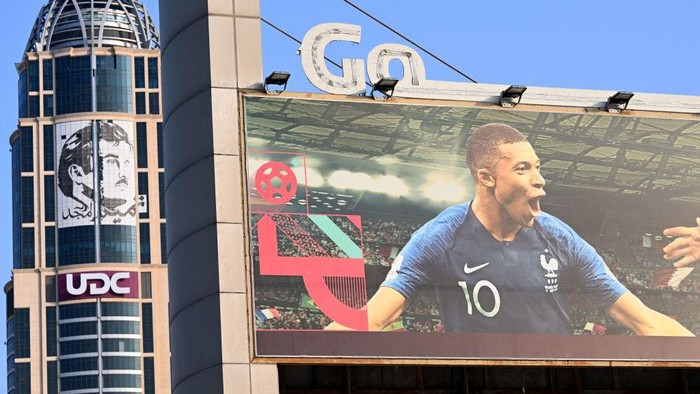 A billboard with a picture of Frances striker Kylian Mbappe is displayed in front of a portrait of Qatars Emir Sheikh Tamim bin Hamad al-Thani in Doha on November 8, 2022, ahead of the Qatar 2022 FIFA World Cup football tournament. (Photo by Gabriel BOUYS / AFP) (Photo by GABRIEL BOUYS/AFP via Getty Images)