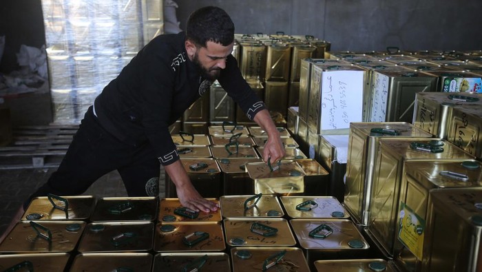 Palestinian workers are seen hand filtering olive oil in Khan Yunis, Gaza Strip on November 07, 2022. Olive oil produced in the Gaza Strip is exported to Arab countries.  (Photo by Majdi Fathi/NurPhoto via Getty Images)