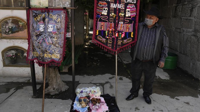 Decorated humans skulls sit on display at the General Cemetery to be blessed by a priest at the annual 