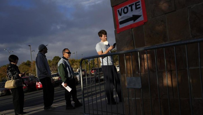 People wait in line to vote at a polling place Tuesday, Nov. 8, 2022, in Las Vegas. (AP Photo/John Locher)