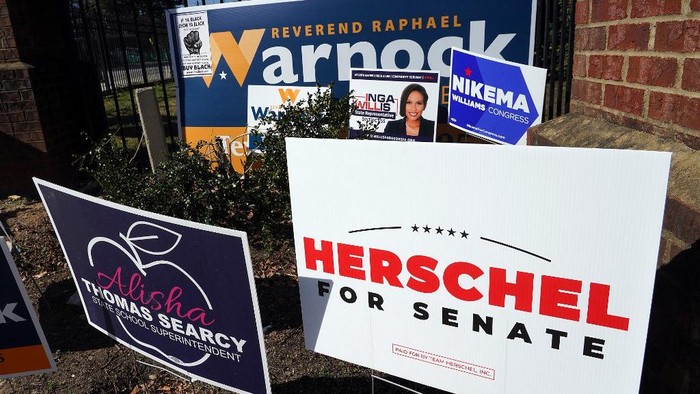 Signs are pictured outside of a polling station at C.T. Martin Natatorium and Recreation Center during the US midterm election, in Atlanta, Georgia on November 8, 2022. (Photo by TAMI CHAPPELL / AFP)