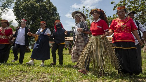 Indigenous people bring their agricultural products to the produce carnival at the opening of the Mosintuwu Festival in Tentena, Poso Regency, Central Sulawesi Province, Indonesia on November 9, 2022. After a two-year hiatus due to the COVID-19 pandemic, the cultural festival with the theme Remembering, Maintaining, and Celebrating Poso Cultural Traditions was held again and was attended by indigenous people from 20 village representatives and four local tribes, namely Pamona, Mori, Bada, and Napu. The festival, which emphasizes the participation of indigenous peoples, features a variety of cultural attractions and traditions of each tribe including its culinary peculiarities. (Photo by Basri Marzuki/NurPhoto via Getty Images)