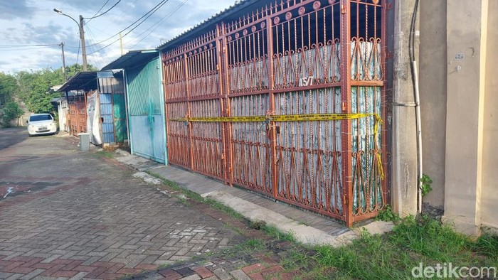Empat jenazah yang merupakan satu keluarga ditemukan di sebuah rumah di kawasan Kalideres, Jakbar. Garis polisi tampak terpasang di pagar rumah tersebut. (Rumondang N/detikcom)