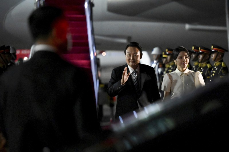 South Korean President Yoon Suk Yeol and his wife Kim Keon-hee arrive at Ngurah Rai International Airport in Bali, Indonesia, Sunday, Nov. 13, 2022. President Yoon Suk Yeol is planning to attend the G20 summit meeting in Nusa Dua. (Sonny Tumbelaka/Pool Photo via AP)