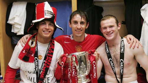 CARDIFF, WALES - FEBRUARY 26: Cristiano Ronaldo, Gary Neville and Wayne Rooney of Manchester United pose with the Carling Cup trophy in the dressing room after the Carling Cup Final match between Manchester United and Wigan Athletic at The Millennium Stadium on February 26 2006 in Cardiff, Wales. (Photo by John Peters/Manchester United via Getty Images)