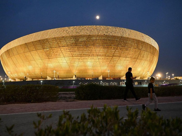 DOHA, QATAR - NOVEMBER 14: Images of Gareth Bale of Wales, Hassan Al-Haydos of Qatar and the FIFA World Cup trophy are seen on sky scrapers in the West Bay area ahead of the FIFA World Cup Qatar 2022 on November 14, 2022 in Doha, Qatar. (Photo by Catherine Ivill/Getty Images)