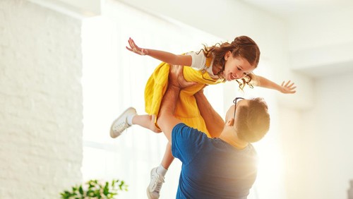Fathers day. Happy family daughterhugs his dad  on holiday