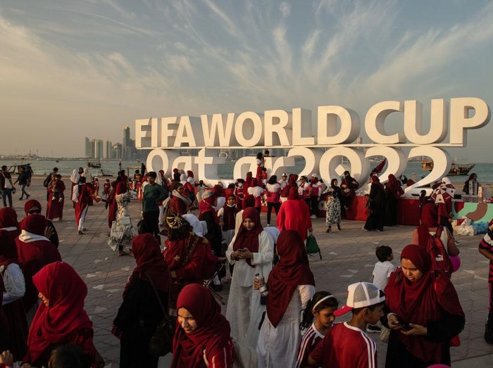 DOHA, QATAR - NOVEMBER 12: Members of the Ladies Mega Fans football supporters group gather at the Corniche next to the Fifa World Cup logo ahead of the FIFA World Cup Qatar 2022 on November 12, 2022 in Doha, Qatar. (Photo by David Ramos - FIFA/FIFA via Getty Images)