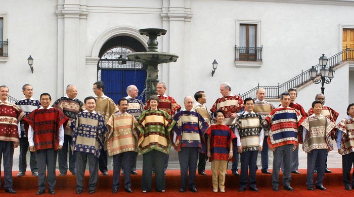 SANTIAGO, CHILE:  CORRECTION-NAMES/ORDER The APEC leaders pose for the family picture, 21 November 2004 at La Moneda Presidential Palace in Santiago. From L to R (front row): Mexican President Vicente Fox; Indodonesia's President Susilo Bambang Yudhoyono; Thai Prime Minister Thaksin Shinawatra; Brunei Sultan Hassanal Bolkiah;  New Zealand Prime Minister Helen Clark; Chile's President Ricardo Lagos; Phillipine President Gloria Arroyo, China's President Hu Jintao, Singapore's Prime Minister Lee Hsien Loong, South Korea President Roh Moo-Hyun and Peru's President Alejandro Toledo. Pictured in second row (L to R) Malaysia's Prime Minister Abdula Ahman Badawi; Hong Kong's Chief Executive Tung Chee-Hwa; Taiwan representative Lee Yuan-tseh, Australian Prime Minister John Howard;  US President George Bush; Vietnam President Tran Duc Luong; Canadian Prime Minister Paul Martin,  Russian President Vladimir Putin, Japan's Prime Minister Junichio Koizumi and Papua New Guinea Prime Minister Michael Somare.   AFP PHOTO/OMAR TORRES  (Photo credit should read OMAR TORRES/AFP via Getty Images)