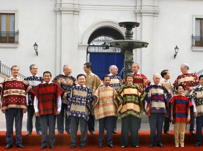 SANTIAGO, CHILE:  CORRECTION-NAMES/ORDER The APEC leaders pose for the family picture, 21 November 2004 at La Moneda Presidential Palace in Santiago. From L to R (front row): Mexican President Vicente Fox; Indodonesia's President Susilo Bambang Yudhoyono; Thai Prime Minister Thaksin Shinawatra; Brunei Sultan Hassanal Bolkiah;  New Zealand Prime Minister Helen Clark; Chile's President Ricardo Lagos; Phillipine President Gloria Arroyo, China's President Hu Jintao, Singapore's Prime Minister Lee Hsien Loong, South Korea President Roh Moo-Hyun and Peru's President Alejandro Toledo. Pictured in second row (L to R) Malaysia's Prime Minister Abdula Ahman Badawi; Hong Kong's Chief Executive Tung Chee-Hwa; Taiwan representative Lee Yuan-tseh, Australian Prime Minister John Howard;  US President George Bush; Vietnam President Tran Duc Luong; Canadian Prime Minister Paul Martin,  Russian President Vladimir Putin, Japan's Prime Minister Junichio Koizumi and Papua New Guinea Prime Minister Michael Somare.   AFP PHOTO/OMAR TORRES  (Photo credit should read OMAR TORRES/AFP via Getty Images)
