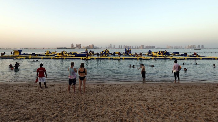 Soccer Football - FIFA World Cup Qatar 2022 - Opening of West Bay Beach, B12 Beach Club and Doha Sands Beach Club - Doha, Qatar - November 16, 2022 Women pose for a picture on the beach ahead of the World Cup REUTERS/Hamad I Mohammed