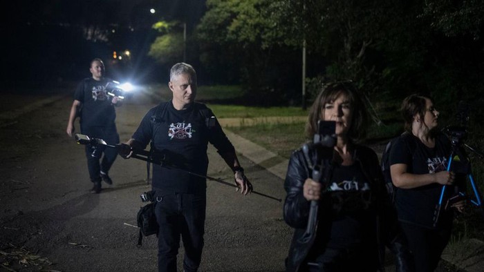 Members of the ghost hunters group, The Upsidedown, walk through abandoned buildings while investigationg paranormal activities inside one of the top South African university campus' in Pretoria on November 12, 2022. - The Upsidedown, a ghost hunting group consisting of five men and two women, a store employee, a designer and even a former soldier have been hunting ghosts in South Africa for 2 years. They have been questioning ghosts and trapped spirits about the complex and violent history of the country. (Photo by Michele Spatari / AFP) (Photo by MICHELE SPATARI/AFP via Getty Images)