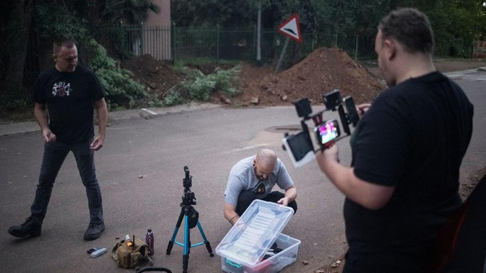 Members of the ghost hunters group, The Upsidedown, prepare to investigate paranormal activities inside one of the top South African university campus' in Pretoria on November 12, 2022. - The Upsidedown, a ghost hunting group consisting of five men and two women, a store employee, a designer and even a former soldier have been hunting ghosts in South Africa for 2 years. They have been questioning ghosts and trapped spirits about the complex and violent history of the country. (Photo by Michele Spatari / AFP) (Photo by MICHELE SPATARI/AFP via Getty Images)