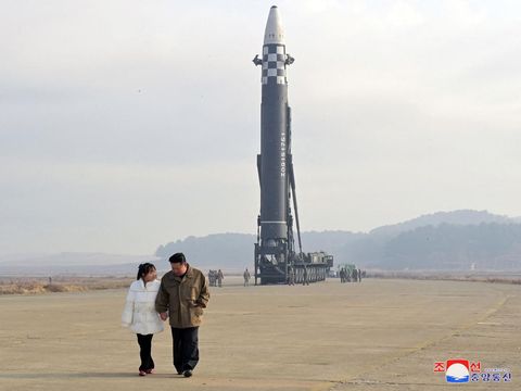 North Korean leader Kim Jong Un, along with his daughter, walks away from an intercontinental ballistic missile (ICBM) in this undated photo released on November 19, 2022 by North Korea's Korean Central News Agency (KCNA). KCNA via REUTERS ATTENTION EDITORS - THIS IMAGE WAS PROVIDED BY A THIRD PARTY. NO THIRD PARTY SALES. SOUTH KOREA OUT. NO COMMERCIAL OR EDITORIAL SALES IN SOUTH KOREA. REUTERS IS UNABLE TO INDEPENDENTLY VERIFY THIS IMAGE.