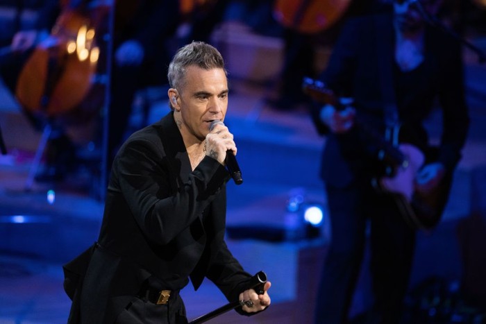 HAMBURG, GERMANY - NOVEMBER 15: Robbie Williams performs live at the Telekom Street Gigs with a large orchestra, new songs and the Beethoven AI at the Hamburg Elbphilharmonie on November 15, 2022 in Hamburg, Germany. (Photo by Andreas Rentz/Getty Images)