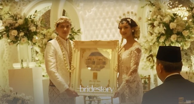 Sebagai mahar, Rendi memberikan logam mulia seberat 50 gram uang  sebesar $22 Singapura, RM11, Rp22 ribu. Keduanya pun berfoto bersama mahar pernikahan mereka. Foto: YouTube/Glenca Chysara