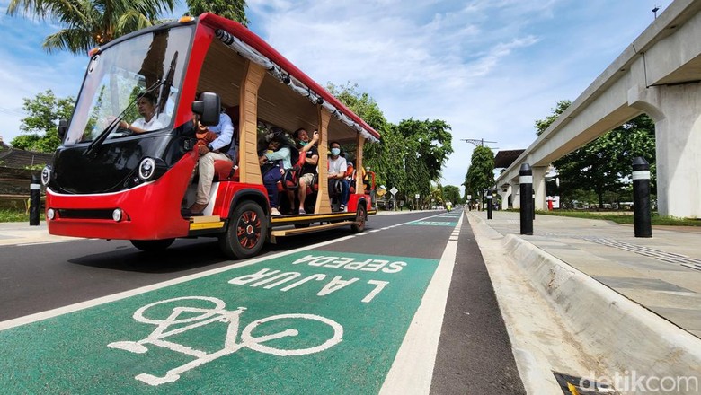 Pesepeda dan pejalan kaki menikmati jalur pedestrian di kawasan Taman Mini Indonesia Indah (TMII), Jakarta Timur, Minggu (20/11/2022).