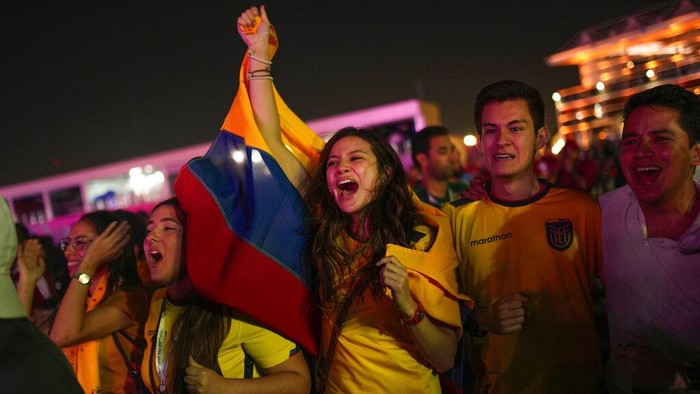 Ecuador fans celebrate their teams second goal as they watch in a giant screen at the fan zone the World Cup group A soccer match between Qatar and Ecuador being played at the Al Bayt stadium in Al Khor, in Doha, Qatar, Sunday, Nov. 20, 2022. (AP Photo/Francisco Seco)