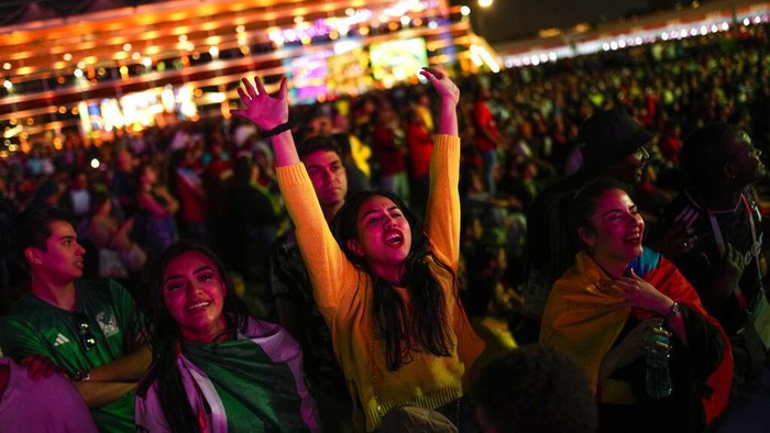 Ecuador fans celebrate their teams second goal as they watch in a giant screen at the fan zone the World Cup group A soccer match between Qatar and Ecuador being played at the Al Bayt stadium in Al Khor, in Doha, Qatar, Sunday, Nov. 20, 2022. (AP Photo/Francisco Seco)