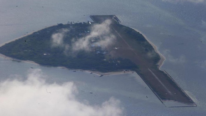 FILE - This photo taken from a C-130 transport plane with Defense Chief Delfin Lorenzana and Armed Forces Chief Gen. Eduardo Ano shows Thitu Island off the South China Sea on April 21, 2017. A Chinese coast guard vessel twice blocked the Philippine naval boat before seizing the debris it was towing Sunday off Philippine-occupied Thitu Island, Vice Admiral Alberto Carlos said Monday., Nov. 21, 2022. (AP Photo/Bullit Marquez, File)