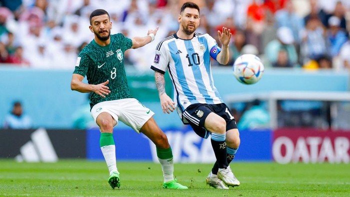 LUSAIL CITY, QATAR - NOVEMBER 22: Abdulellah Al Malki of Saudi Arabia and Lionel Messi of Argentina battle for the ball during the FIFA World Cup Qatar 2022 Group C match between Argentina and Saudi Arabia at Lusail Stadium on November 22, 2022 in Lusail City, Qatar. (Photo by Matteo Ciambelli/DeFodi Images via Getty Images)