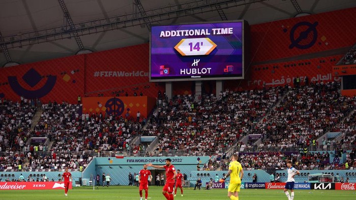 DOHA, QATAR - NOVEMBER 21: A giant screen displays additional time of 14 minutes as Alireza Beiranvand of IR Iran received medical treatment during the FIFA World Cup Qatar 2022 Group B match between England and IR Iran at Khalifa International Stadium on November 21, 2022 in Doha, Qatar. (Photo by Julian Finney/Getty Images)