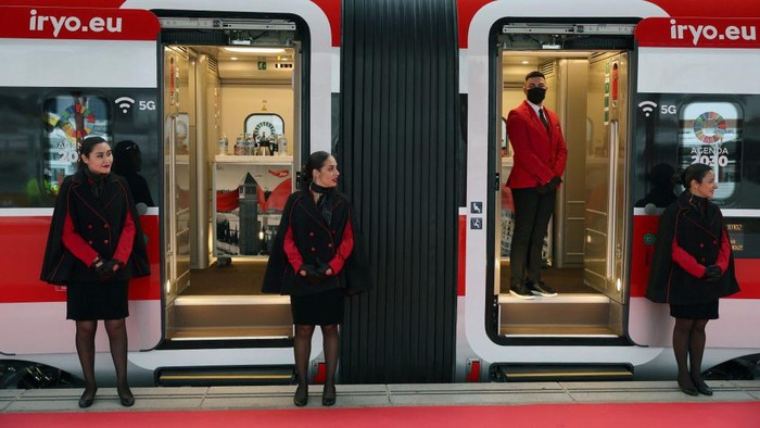Low-cost train Iryos staff members stand at the trains door on the day of its inaugural trip at the Chamartin train station in Madrid on November 21, 2022. - Private high-speed train operator Iryo, which is 45 percent owned by Italys Trenitalia, makes on November 21 a symbolic inaugural trip in Spain, four days before it starts its passenger service between Madrid and Barcelona. (Photo by Pierre-Philippe Marcou / AFP) (Photo by PIERRE-PHILIPPE MARCOU/AFP via Getty Images)