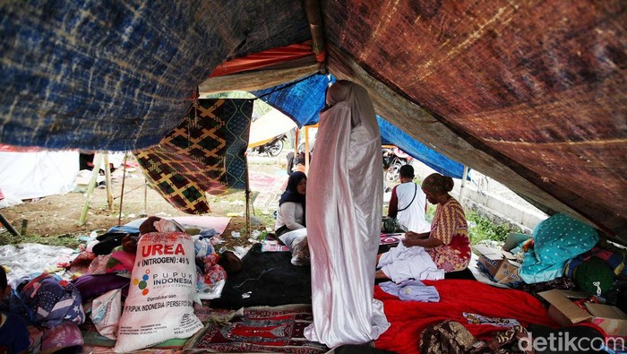 Sejumlah warga mengungsi di tanah kosong pinggir sawah di kawasan Desa Gasol, Kampung Lugewang, Cianjur, Jawa Barat, Selasa (22/11/2022). Menurut keterangan warga mereka masih membutuhkan logistik makanan minuman, air bersih, serta jenset untuk aliran listrik untuk koordinasi bantuan.