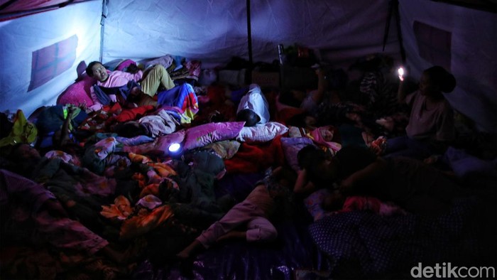 Mereka yang Bertahan di Gelap Gulita Gempa Cianjur Sejumlah warga korban gempa beraktivitas di tenda pengungsian yang gelap gulita di kawasan Desa Gasol, Kecamatan Cugenang, Cianjur, Jawa Barat, Selasa (22/11/2022). Menurut keterangan warga sudah 2 hari listrik di Desa Gasol Kecamatan Cugenang mati total, sehingga mereka meminta bantuan agar listrik kembali dinyalakan atau diberikan bantuan genset sebagai untuk menyalakan daya listrik.