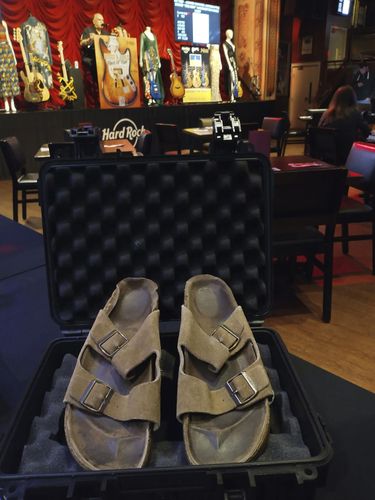 In this photo provided by Julien's Auctions are Steve Jobs' Birkenstock sandals sold at their Idols & Icons Rock N' Roll auction at the Hard Rock Cafe in New York, Sunday Nov. 13, 2022. The California house where Steve Jobs co-founded Apple is a historical site, and now the sandals he wore while pacing its floors have been sold for nearly $220,000, according to an auction house. The 