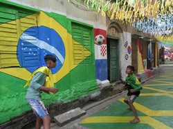 Warga di permukiman tersebut menghias jalanan dengan gambar bendera Brasil sebagai bentuk dukungan untuk Piala Dunia 2022.  
