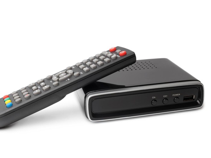 Digital TV tuner with remote control on white background