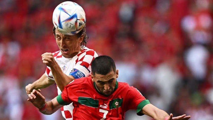 Croatias midfielder #10 Luka Modric and Moroccos midfielder #07 Hakim Ziyech jump for a header during the Qatar 2022 World Cup Group F football match between Morocco and Croatia at the Al-Bayt Stadium in Al Khor, north of Doha on November 23, 2022. (Photo by MANAN VATSYAYANA / AFP) (Photo by MANAN VATSYAYANA/AFP via Getty Images)