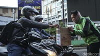 Nampak sejumlah ojol menghampiri para pengendara yang tengah menunggu lampu merah.