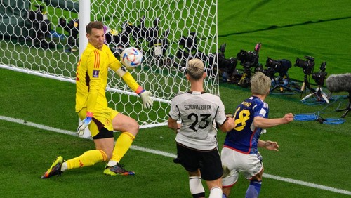 23 November 2022, Qatar, Ar-Rayyan: Soccer: World Cup, Germany - Japan, preliminary round, Group E, Matchday 1, Khalifa International Stadium. Japans Takuma Asano (r) scores against Germanys Nico Schlotterbeck (M) and Germanys goalkeeper Manuel Neuer for 1-2. Photo: Robert Michael/dpa (Photo by Robert Michael/picture alliance via Getty Images)