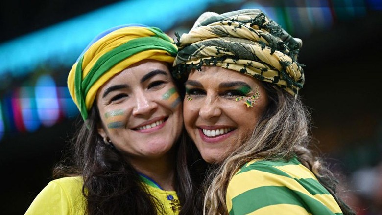 Fans of Brazil pose for a picture on the stands ahead of the Qatar 2022 World Cup Group G football match between Brazil and Serbia at the Lusail Stadium in Lusail, north of Doha on November 24, 2022. (Photo by Anne-Christine POUJOULAT / AFP) (Photo by ANNE-CHRISTINE POUJOULAT/AFP via Getty Images)