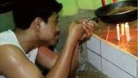 Gas sedang habis, pria yang satu ini punya cara kreatif buat goreng telur. Yaitu dengan menggunakan lilin untuk mati lampu. Kreatif, ya? Foto: Pool/Site
